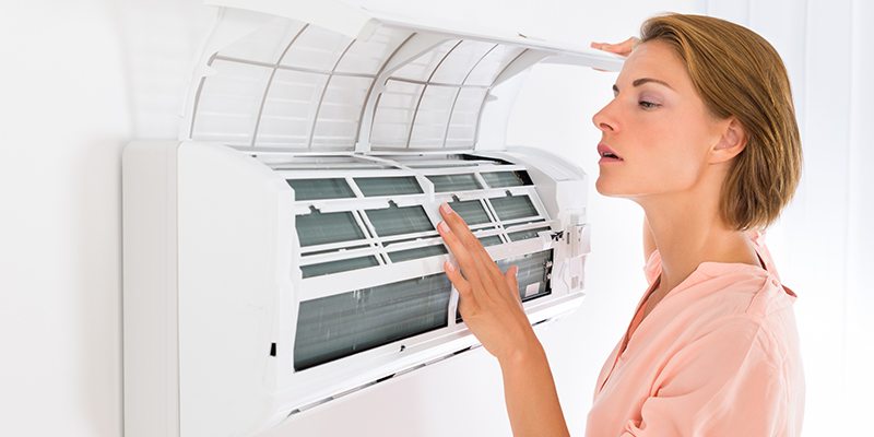 Woman Checking an Air Conditioner