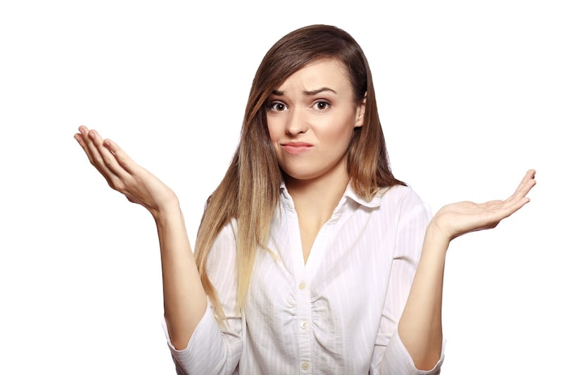 portrait of young woman shrugging her hands isolated on white background in photostudio. What is that heat pump smell?