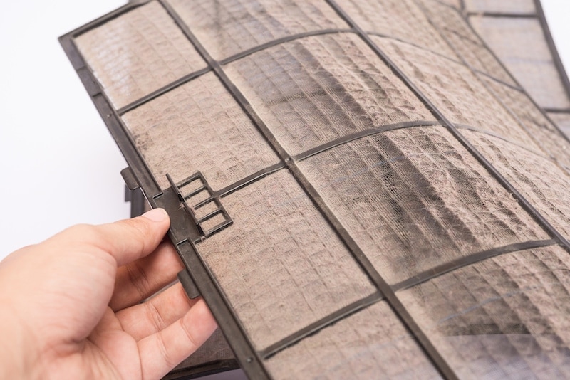 dirty air conditioner filter hand pick up.