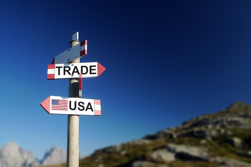 Wooden signs, one pointing to Trade and one pointing to USA.