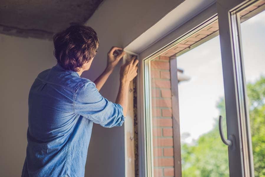 Man insulting a window in Beaufort, NC.