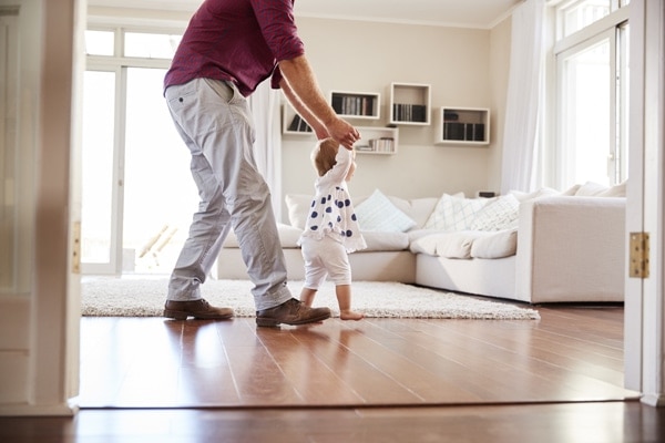 Father playing with child in the living room.