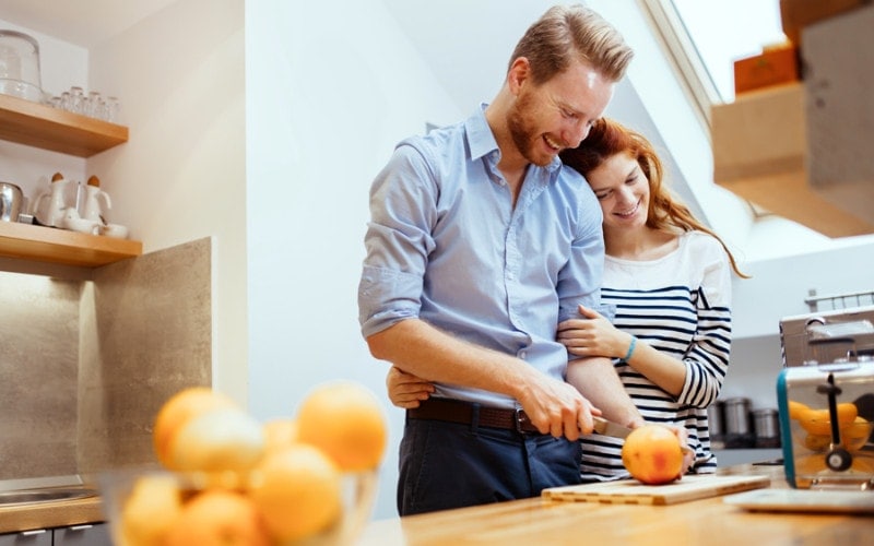 Husband and wife in the kitchen talking about their geothermal heat pump.