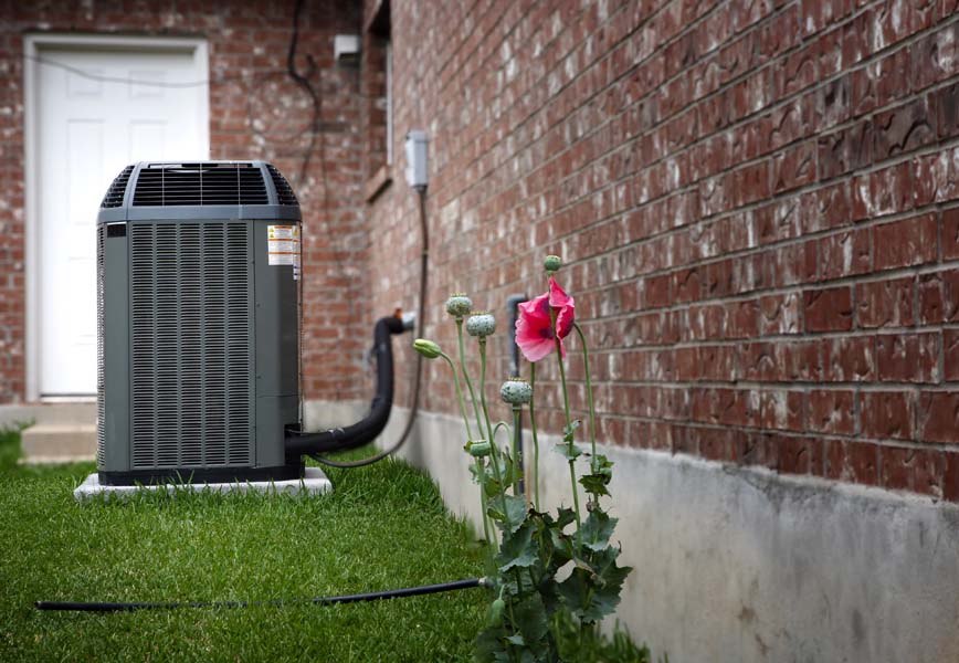 AC in backyard of home representing the top causes of AC failure.