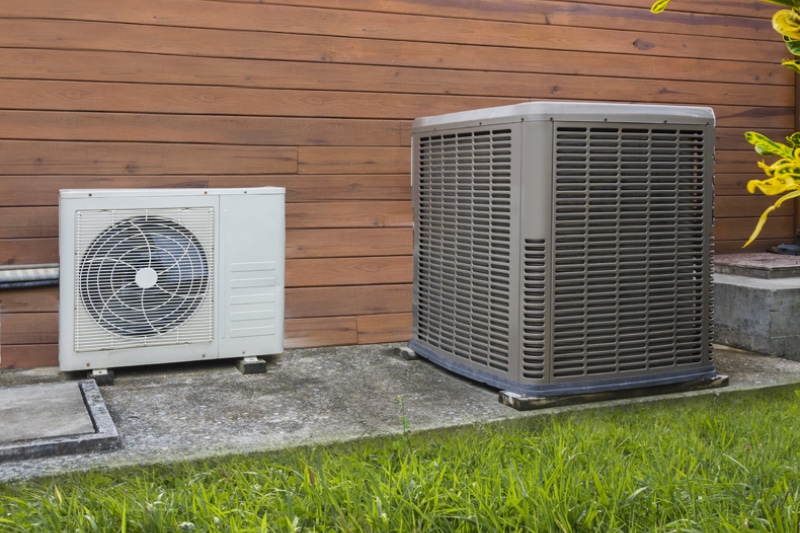 Air conditioning heat pumps on the side of a house.