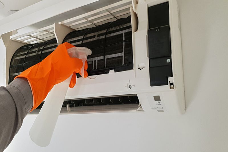 What Maintenance Is Needed for a Ductless System? - Maintenance Person Cleaning a Ductless System.